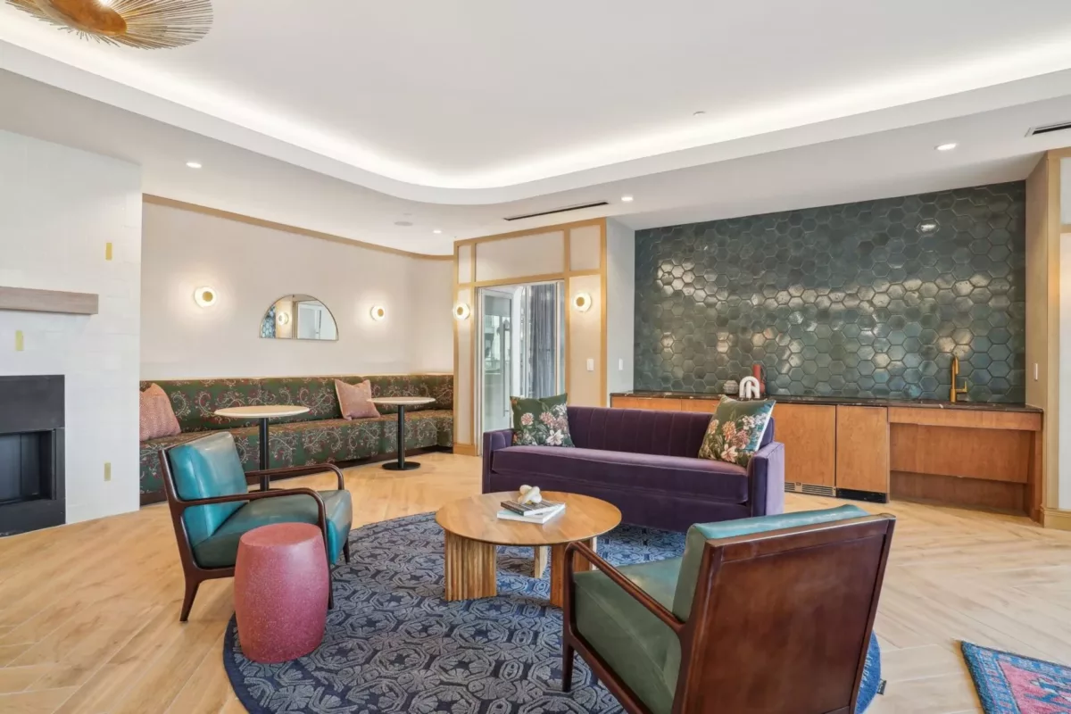Resident lounge with tables, chairs, and fireplace