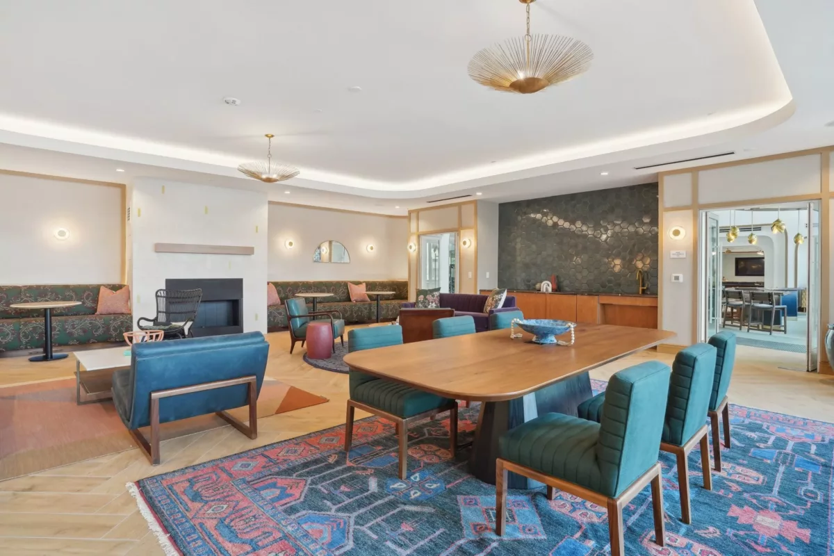 Resident lounge with tables, chairs, and fireplace