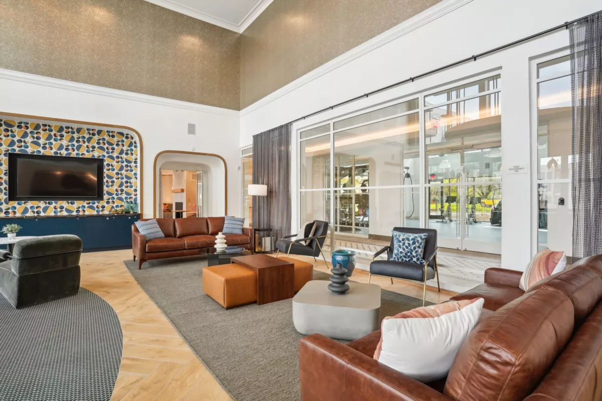 Resident lounge with tables, chairs, and fireplace
