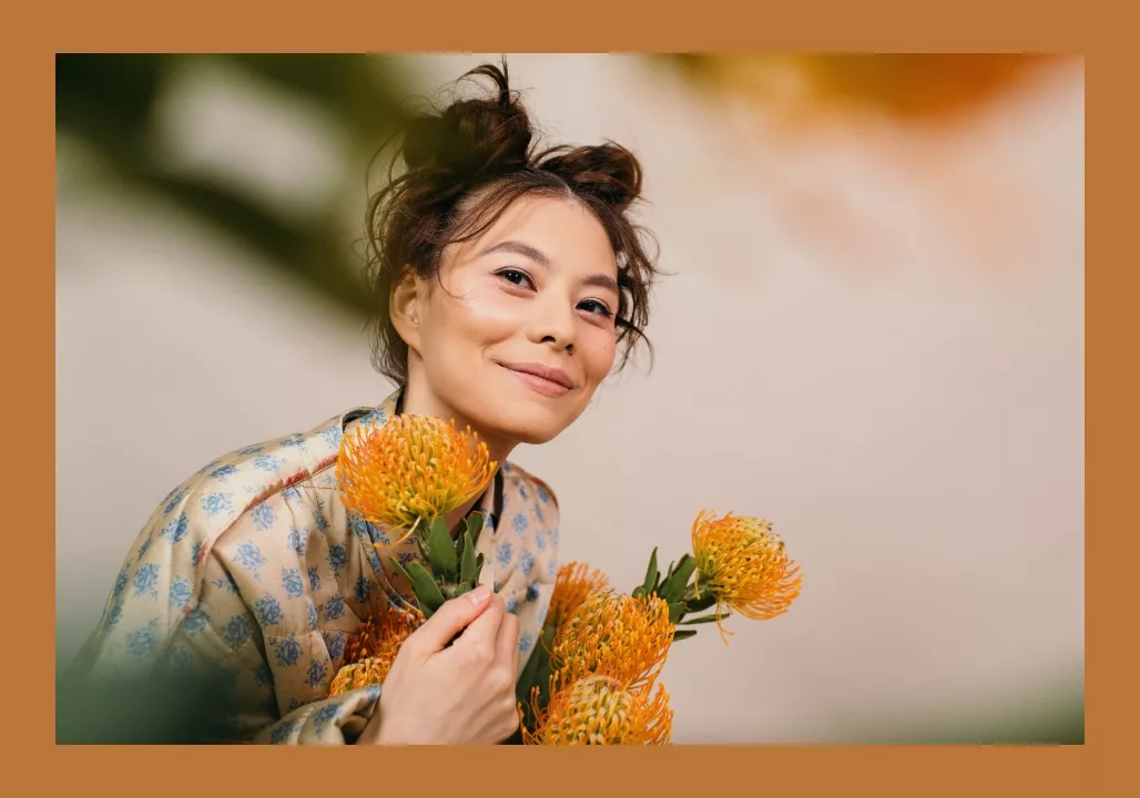 Woman with flowers smiling