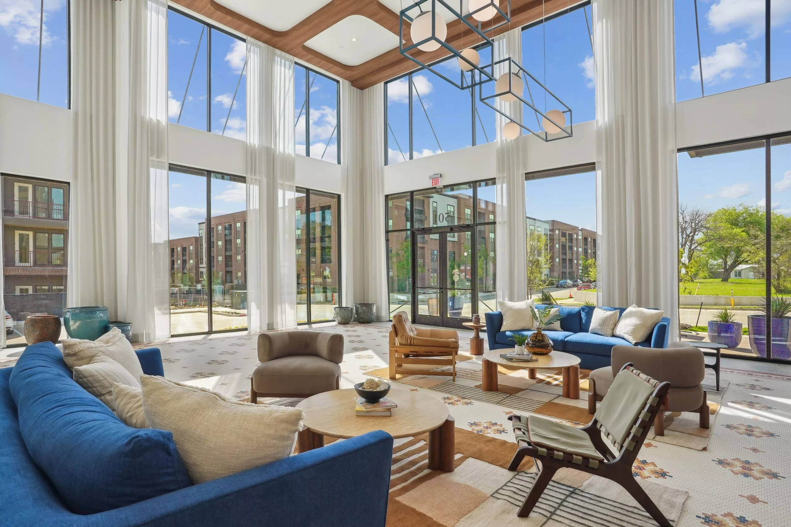 Resident lounge with tables, chairs, and fireplace